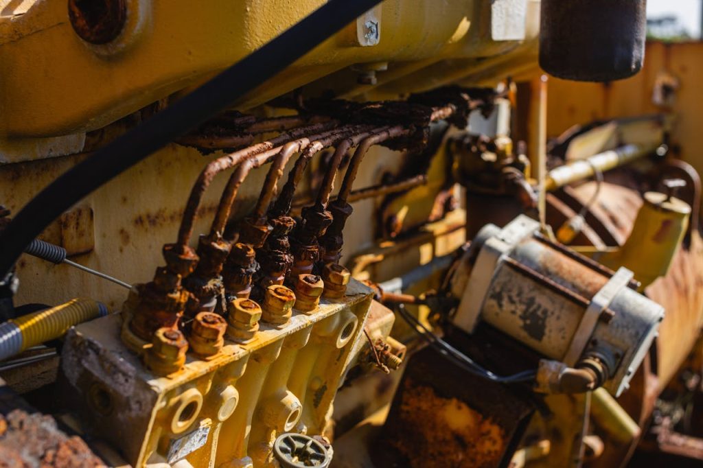 A close up of an old engine with wires and pipes